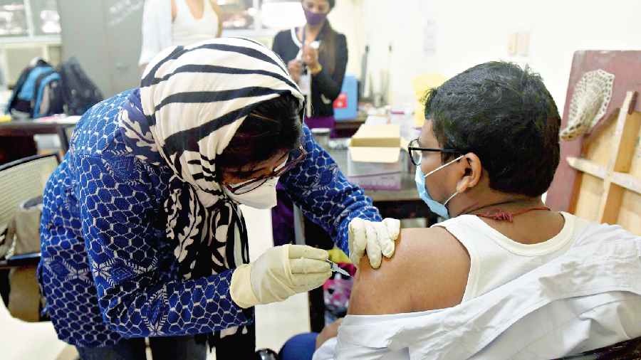 A recipient gets a Covid vaccine shot in the city