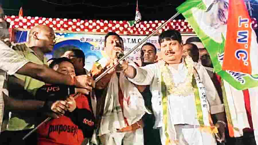 Arjun Singh hands over a Trinamul flag to his followers who joined the party at Kankinara on Tuesday. 