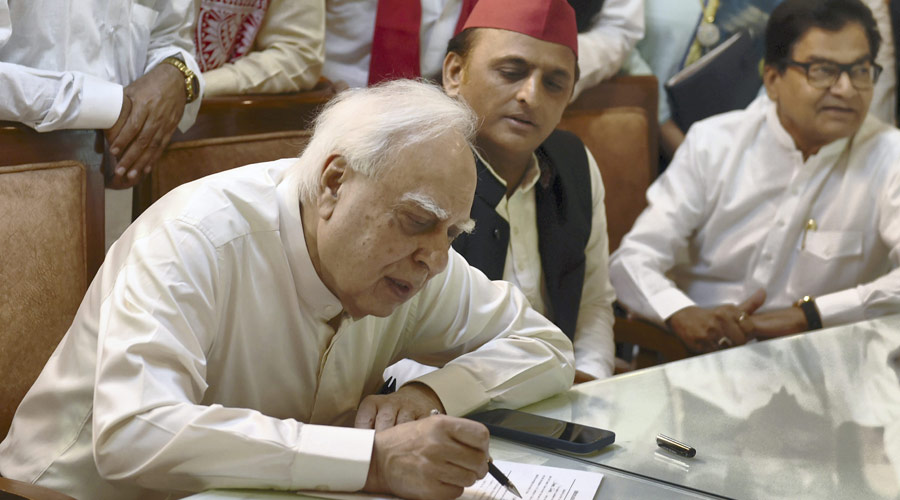 Former Congress leader Kapil Sibal files his nomination papers for Rajya Sabha in the persence of Samajwadi Party President Akhilesh Yadav, at Vidhan Bhawan in Lucknow on Wednesday.