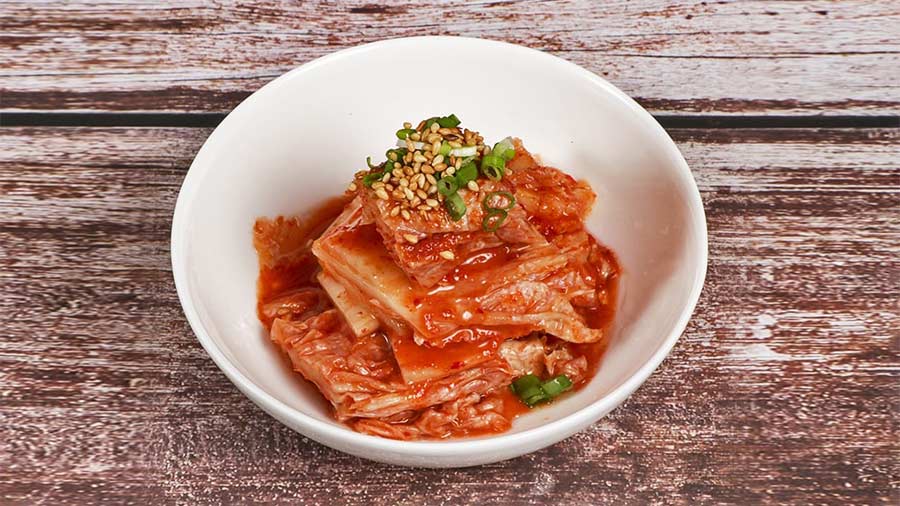 Kimchi is a Korean staple made with fermented veggies and can be enjoyed in various forms, from kimchi chicken to kimchi pancakes.