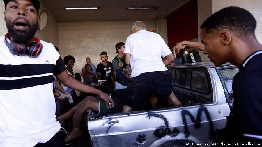 Wounded people arrive at the Getulio Vargas Hospital, the result of a police raid on the Vila Cruzeiro favela in Rio de Janeiro