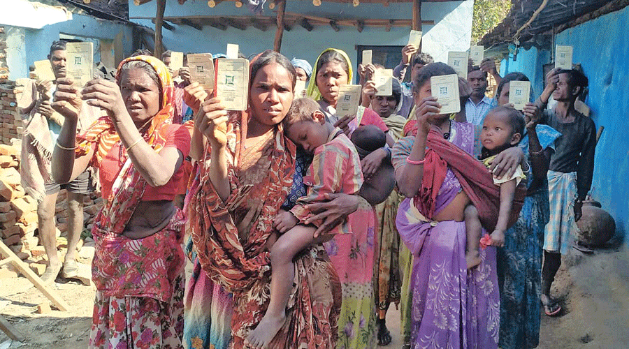 PTG villagers in Garhwa district not receiving ration show their ration cards last year.