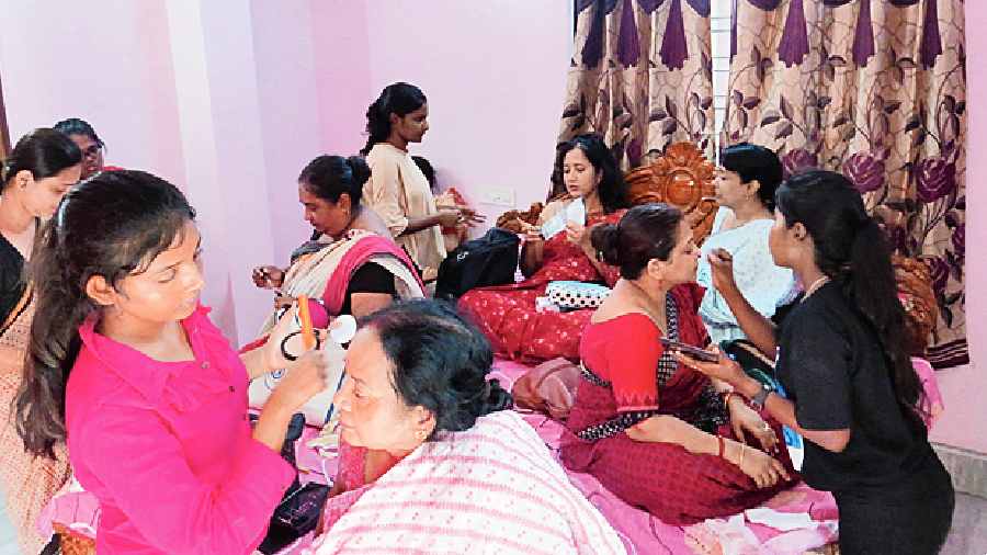 The female members of the cast busy with make-up. 