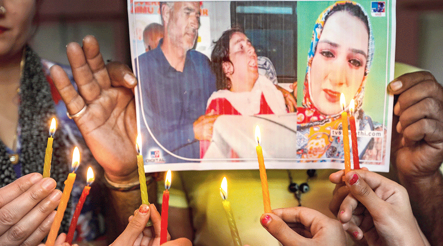 Students of a dance institute light candles to pay tribute to Ambreen Bhat in Jammu  on Thursday.