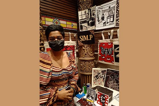 Simran Pujari, an Interior Designing student from INIFD, Lindsay Street, Kolkata, at her stall SIM.P. “I have been selling my illustrations since 2019. My products include stickers, postcards, and tote bags. I paint on them,” said Siman.