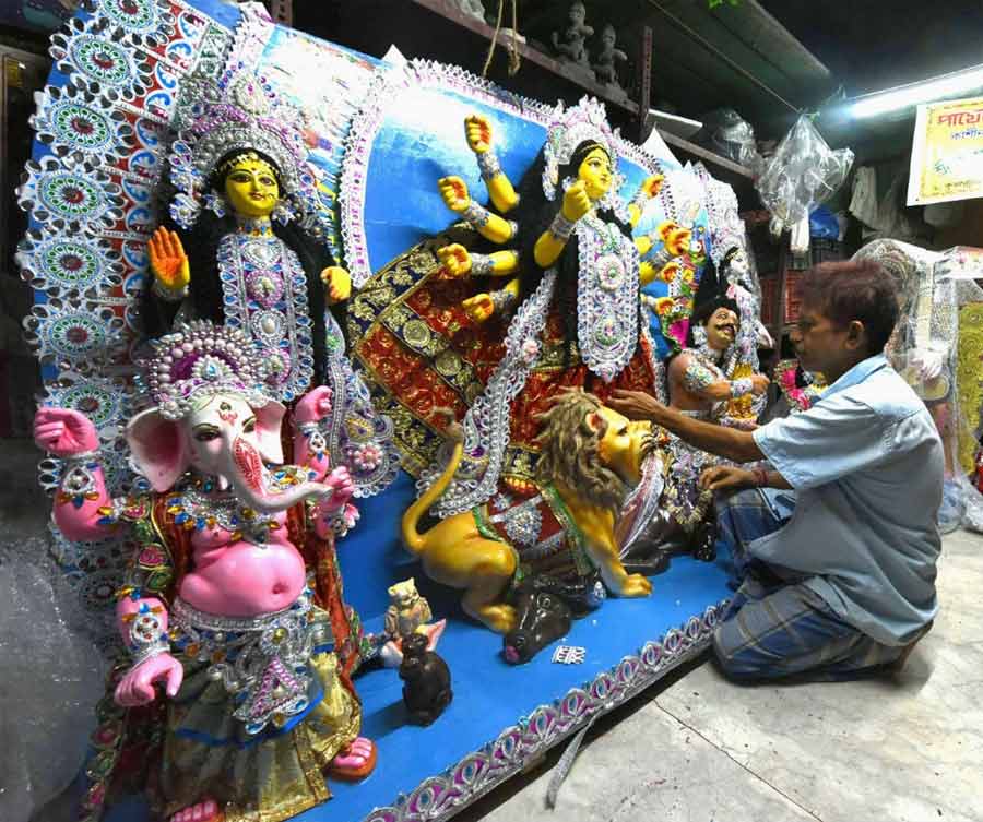 FOREIGN SHORES BECKON: Basu Dev Paul lends finishing touches to a Durga idol at Kumartuli on Saturday, May 28. This idol will be shipped to Maryland, USA