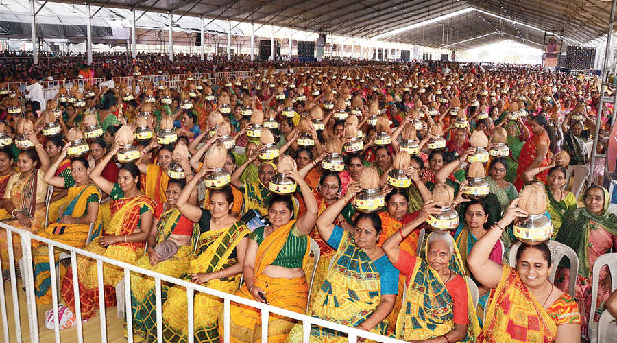 Women hold on their heads pots plastered with the pictures of BJP leaders, including Prime Minister Narendra Modi, at the inauguration of a multi-speciality hospital at Atkot in Gujarat’s Rajkot on Saturday. Modi inaugurated the hospital. Modi’s motorcade was also greeted by women carrying on their heads similar pots.