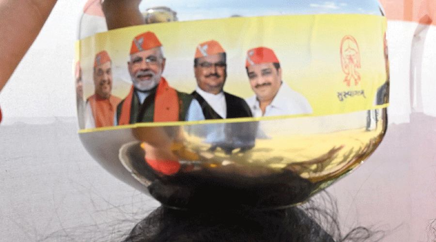 A pot plastered with the pictures of BJP leaders.