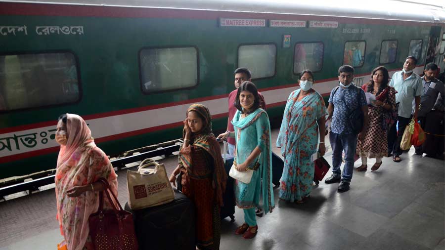 People waiting to board the Maitree Express at Kolkata station on Sunday