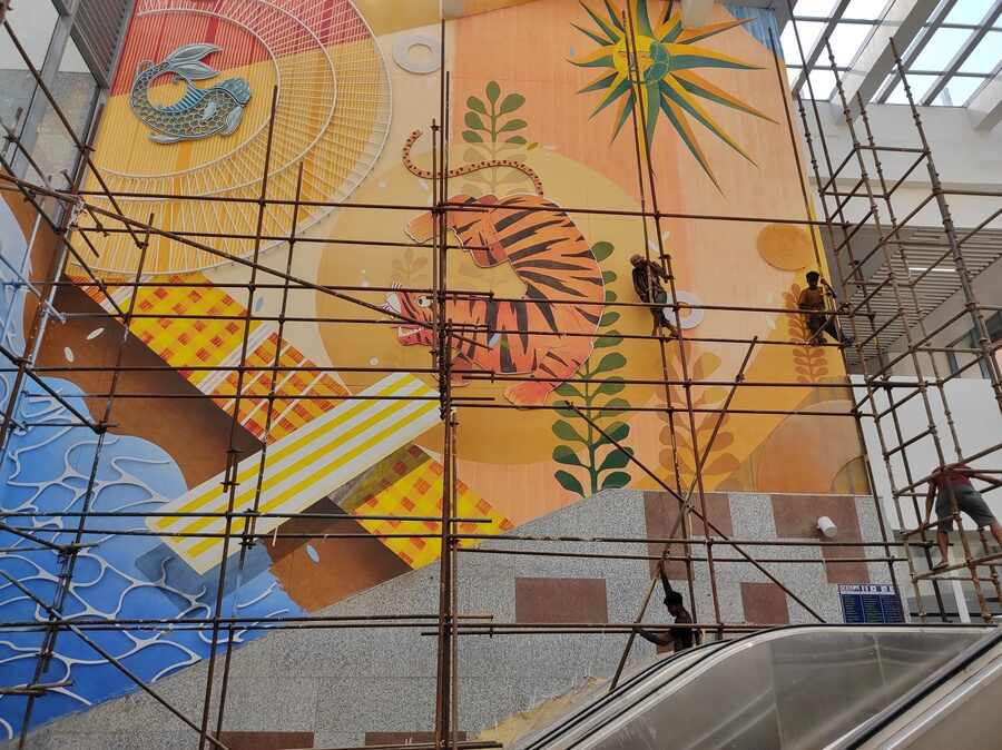Workers lend finishing touches to a giant mural of a tiger at the Sealdah Metro station on Monday 