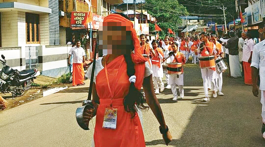 A person carrying a sword leads the Durga Vahini march near Thiruvananthapuram city on May 22. Many of those following her are carrying long sticks. (Face masked by this newspaper as it is not clear whether she is an adult or a minor)