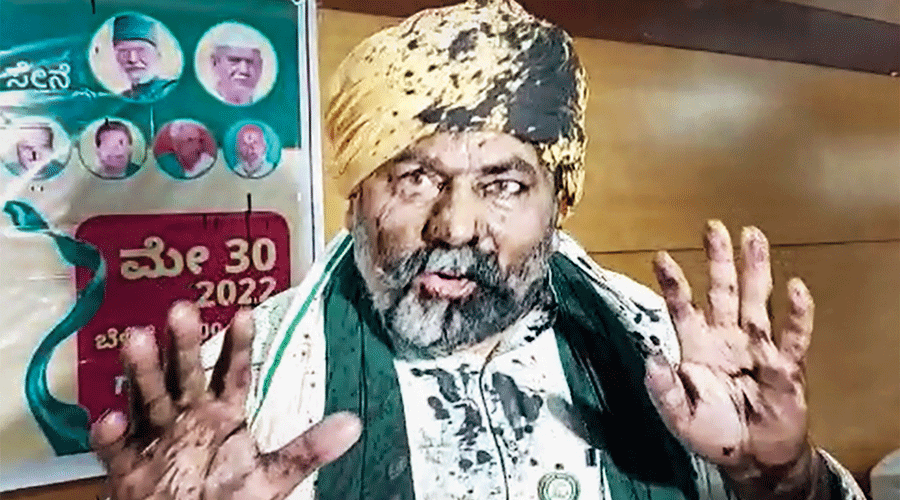 BKU Spokesperson and farmer leader Rakesh Tikait interacts with media after an unidentified person threw ink on him, during an event, in Bengaluru on Monday.