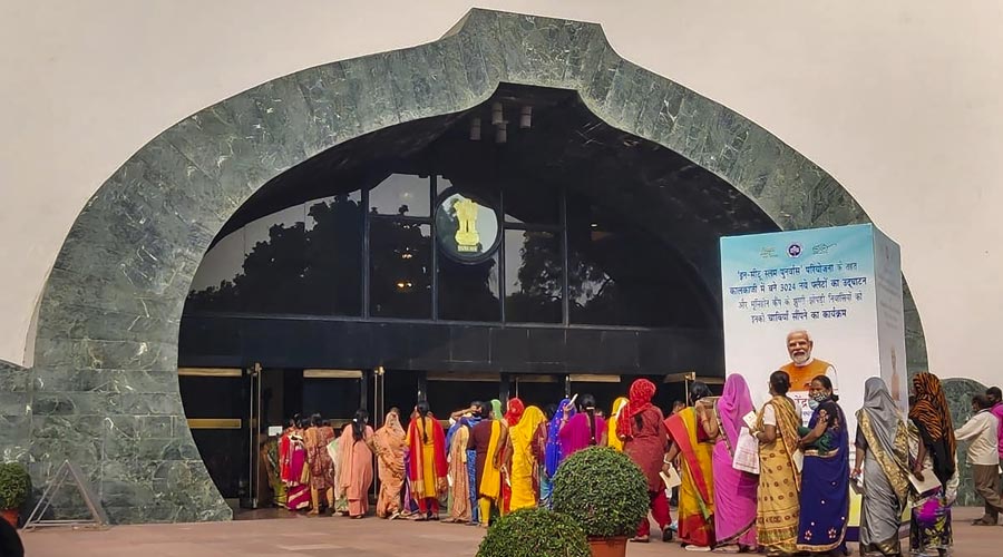 Slum-dwellers of Bhoomiheen Camp, eligible to receive the newly-constructed EWS flats as part of the 'In-Situ Slum Rehabilitation' project, arrive at the event for the flats' inauguration and hand-over of keys to the beneficiaries, at Vigyan Bhawan in New Delhi.