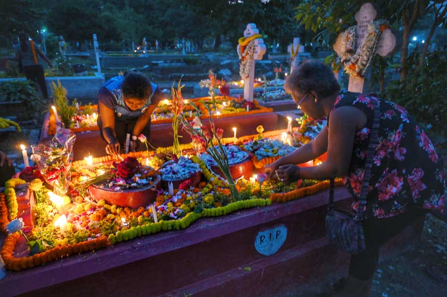 People light candles at the graves of their beloved at Lower Circular Road Cemetery. On All Souls’ Day, people remember their loved ones by visiting their graves and offering prayers, flowers and candles. 