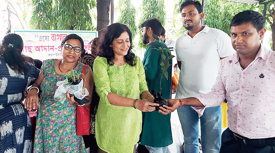 Members of the Bagan group exchange saplings
