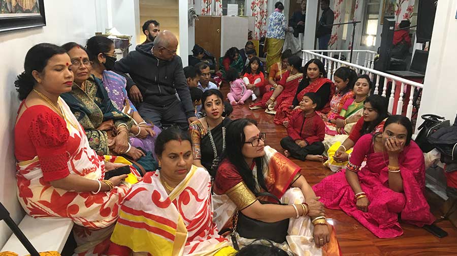 Devotees and patrons attend the puja