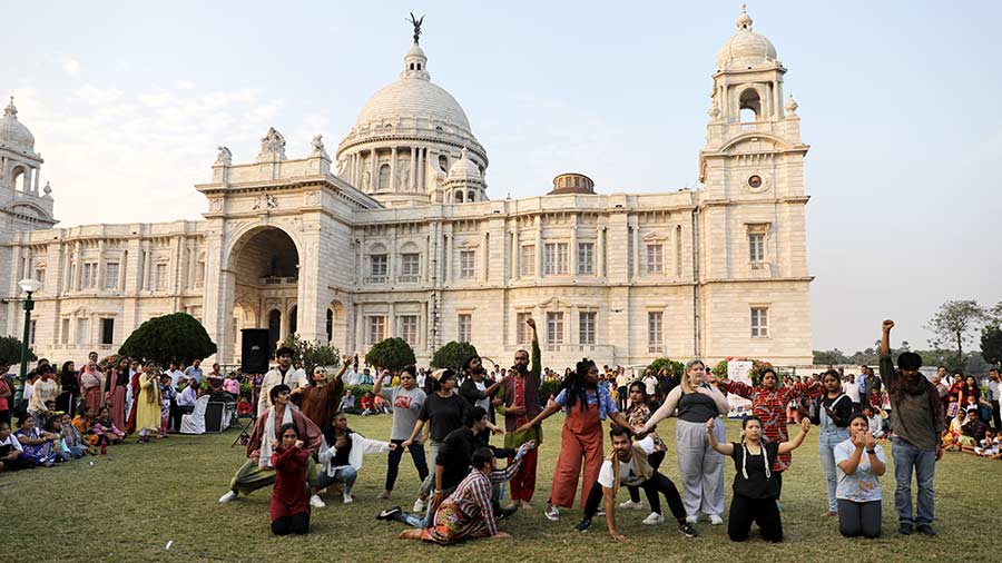 Performers in action with Victoria Memorial in the backdrop