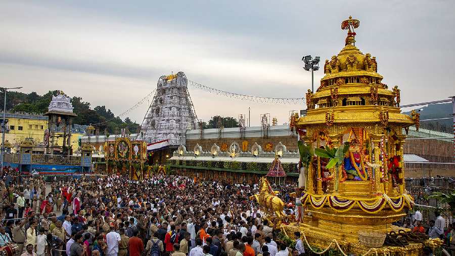Devotees pull 'Swarna Ratham' during ongoing 'Navaratri Brahmotsavam' celebrations, at Tirumala