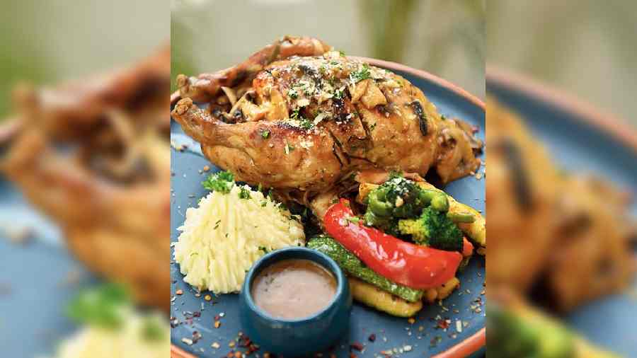 Roasted Spring Chicken in Mushroom Jus: Whole chicken/half a chicken depending on your choice is cooked in the oven and served with a mushroom glaze dip as well as mashed potatoes and veggies. A  filling shared meal.