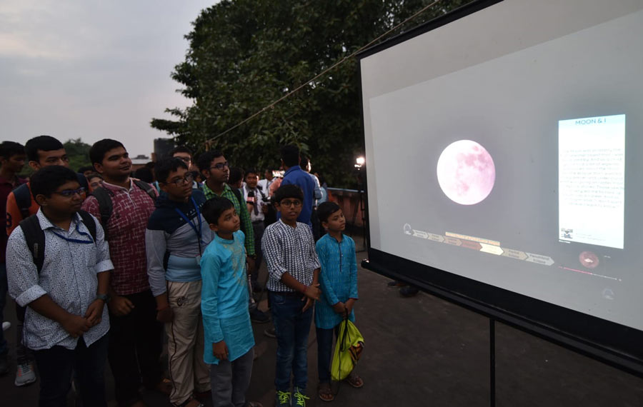 Young kids check out the lunar eclipse in progress on a screen. Prior to that, the BITM had organised a hands-on workshop on total lunar eclipse between 3pm and 4pm