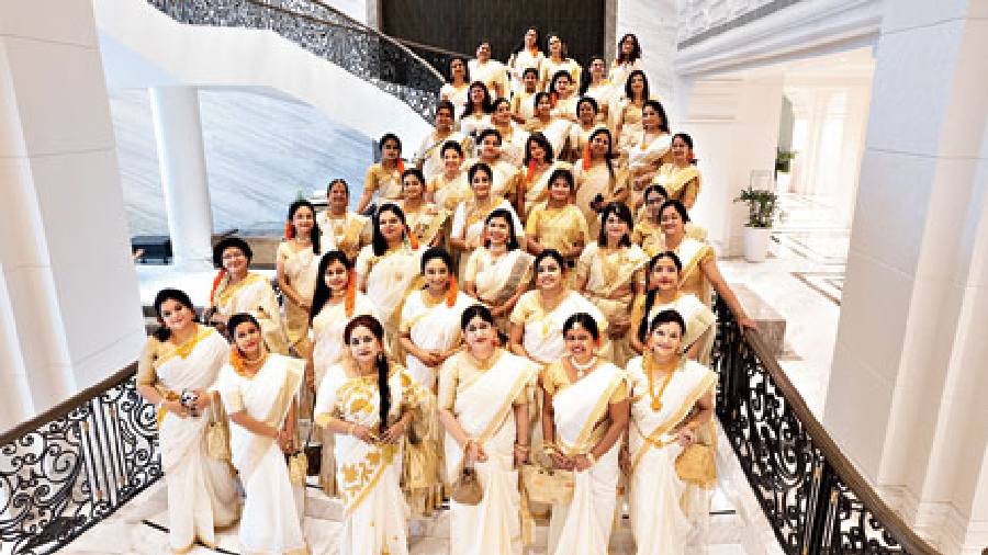 42 doctors in colour-coordinated saris make a great picture on the ITC Royal Grand staircase
