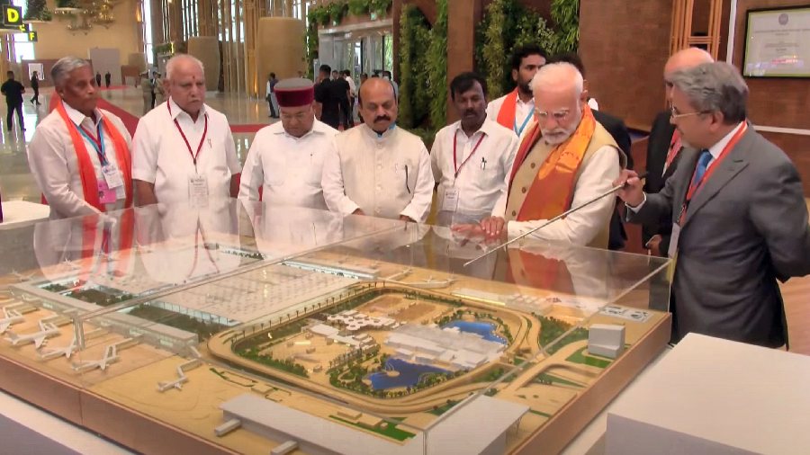 Prime Minister Narendra Modi looks at a model of the newly-inaugurated Terminal 2 of Kempegowda International Airport, in Bengaluru, Friday, November 11, 2022. Karnataka Governor Thaawarchand Gehlot and CM Basavaraj Bommai are also seen.