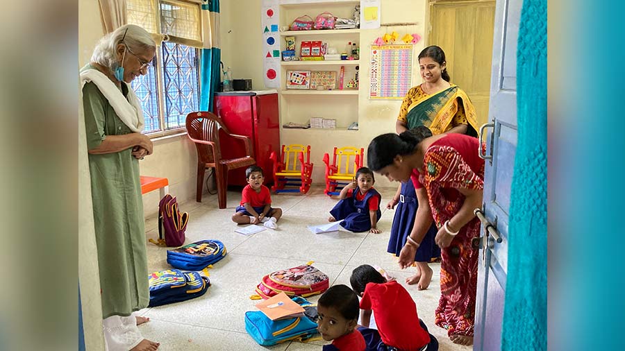 Kalpana Dasgupta (left), trustee, READ India, looks on as the children of the playschool demonstrate their artistry