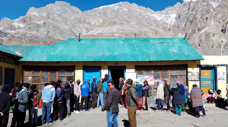 Voters wait in a queue to cast their votes for the Himachal Pradesh Assembly elections, in Lahaul & Spiti district.