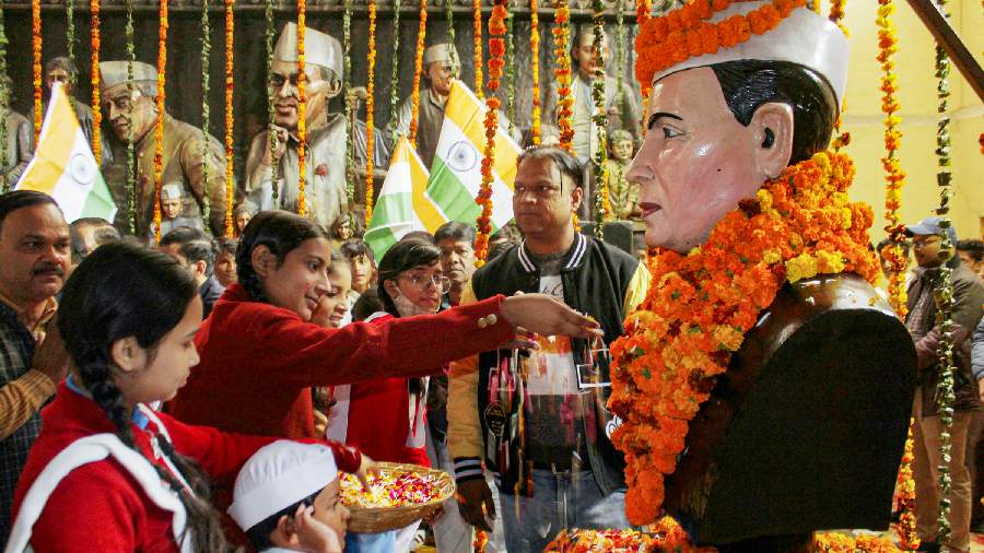In Dehradun, school students pay floral tribute to India's first prime minister Jawaharlal Nehru on his birth anniversary. 