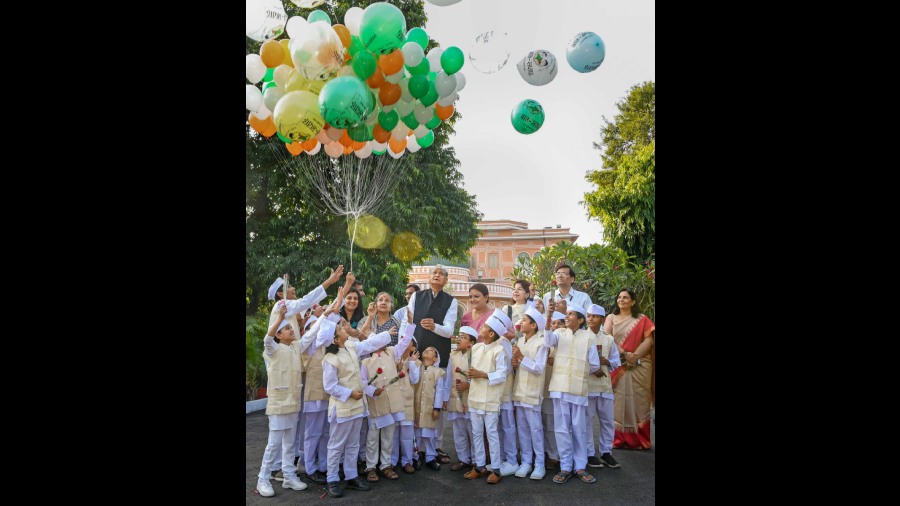 Rajasthan Chief Minister Ashok Gehlot with children dressed as India's first prime minister Jawaharlal Nehru on his birth anniversary, celebrated as Children's Day, in Jaipur. 