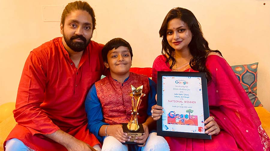 Shlok and his parents with the award and certificate from Google