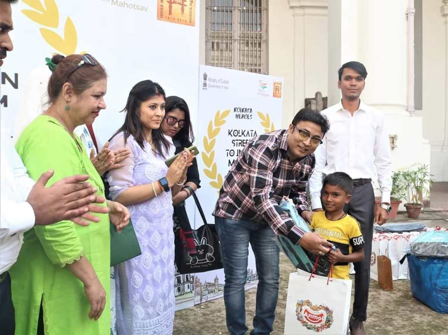 A child receives a gift kit at the programme. These kits were distributed to children who attended the event. The kids later also enjoyed a sumptuous meal