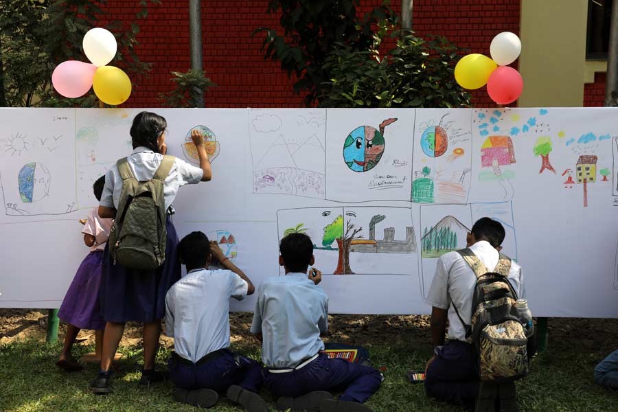 Kids try their hand at painting. A large open-air canvas was installed for them. The theme of the event revolved around environment issues and saving the planet