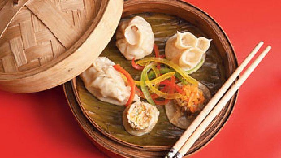 Assorted Dimsums come in different shapes and have stuffing like prawn, chicken and vegetables and is served with chilli garlic sauce