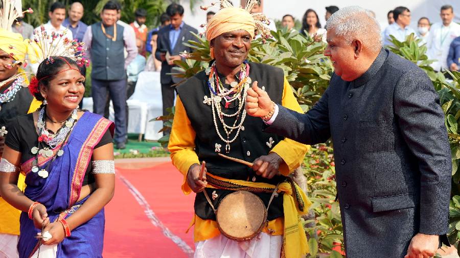 Vice President Jagdeep Dhankhar interacts with a drummer after paying tribute to freedom fighter Birsa Munda on his birth anniversary, at Parliament House complex in New Delhi. 