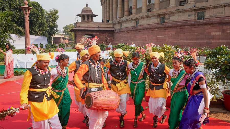 Folk artists perform on the occasion of Birsa Munda's birth anniversary, at Parliament House complex in New Delhi. 