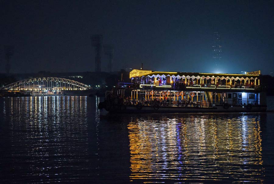 An illuminated river cruise sails on Ganga on Tuesday evening