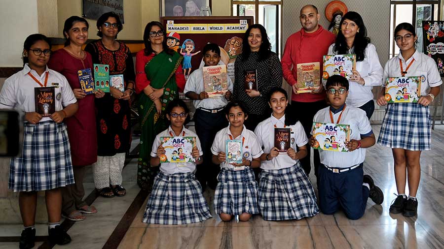 Students of Mahadevi Birla World Academy, vice principal Nupur Ghosh and the authors pose for a group photo