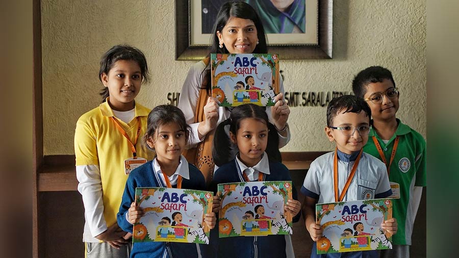 Students pose with Swati Kheria and her book ‘ABC Safari’