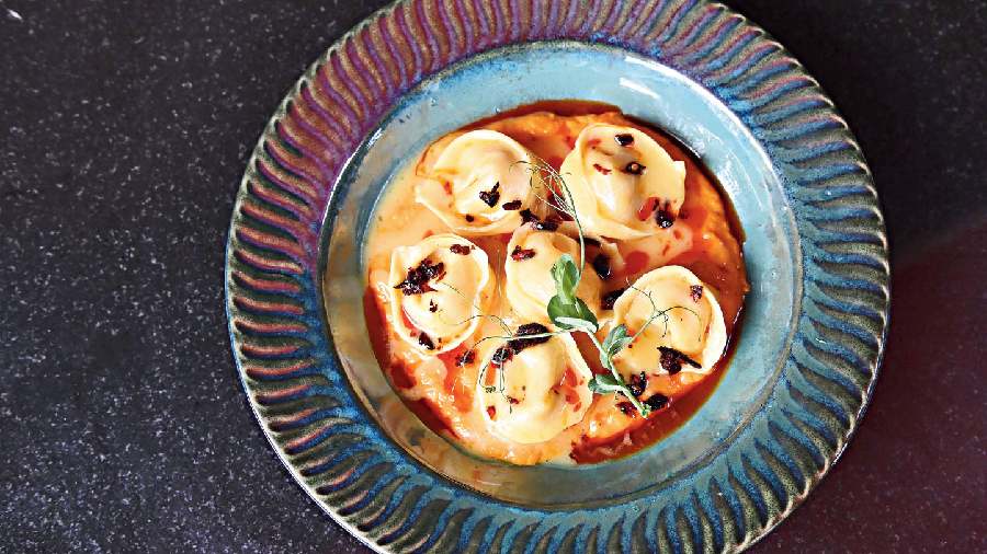 Parmesan Tortellini with Truffle Butter and Carrot Cream is a soft dumpling in a creamy carrot-based sweet- and-cheesy sauce.