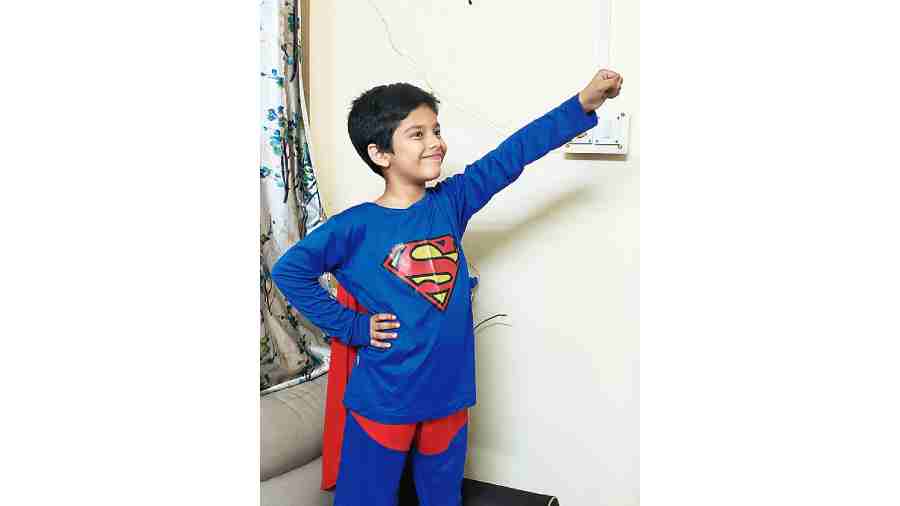 A child in a Superman suit.