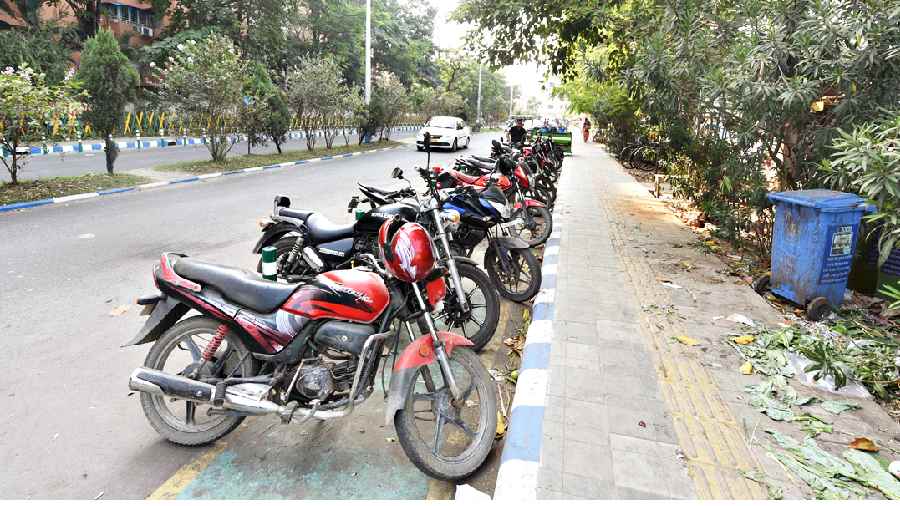 Two-wheelers parked on a bicycle track near the DLF building in New Town on Sunday