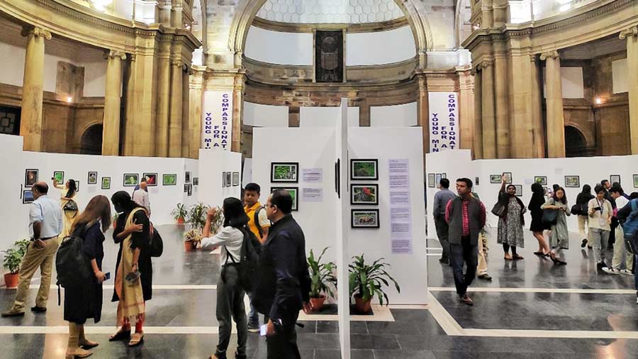 Visitors take a glance at the photographs by the students and mentors 