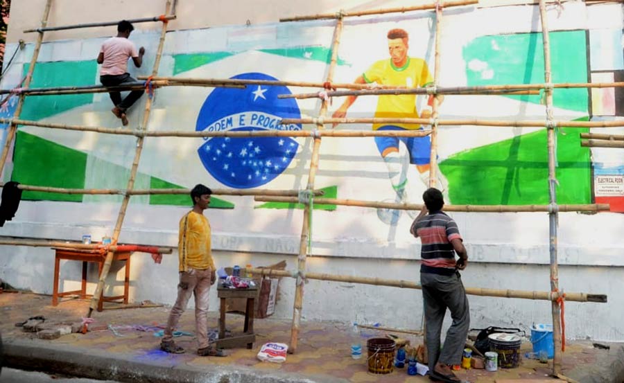 A wall graffiti of the Brazil flag painted by supporters at Gopal Nagar in south Kolkata in the run-up to the biggest football event