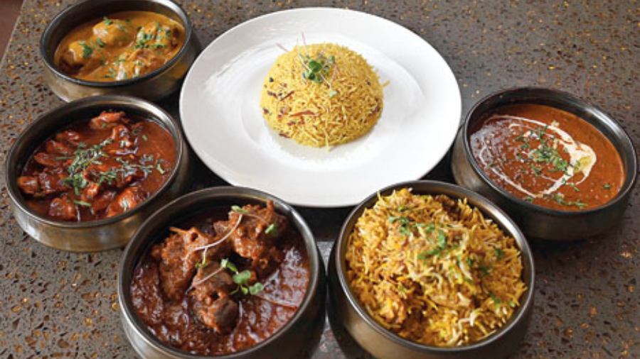 The main course is an extensive affair. (From l-r) Almond and Water Chestnut Kofta Curry, Chicken in Oyster Sauce, Mutton Rogan Josh, Murgdum Biryani, and Dal Tadka along with Kaju Barista Pulao (centre). The kofta is soft and sweet while the rogan josh is lightly spiced with thoroughly cooked mutton. The chicken in oyster sauce is a thick gravy preparation with hints of sweetness. Both the pulao and biryani are light and not overpowering in taste