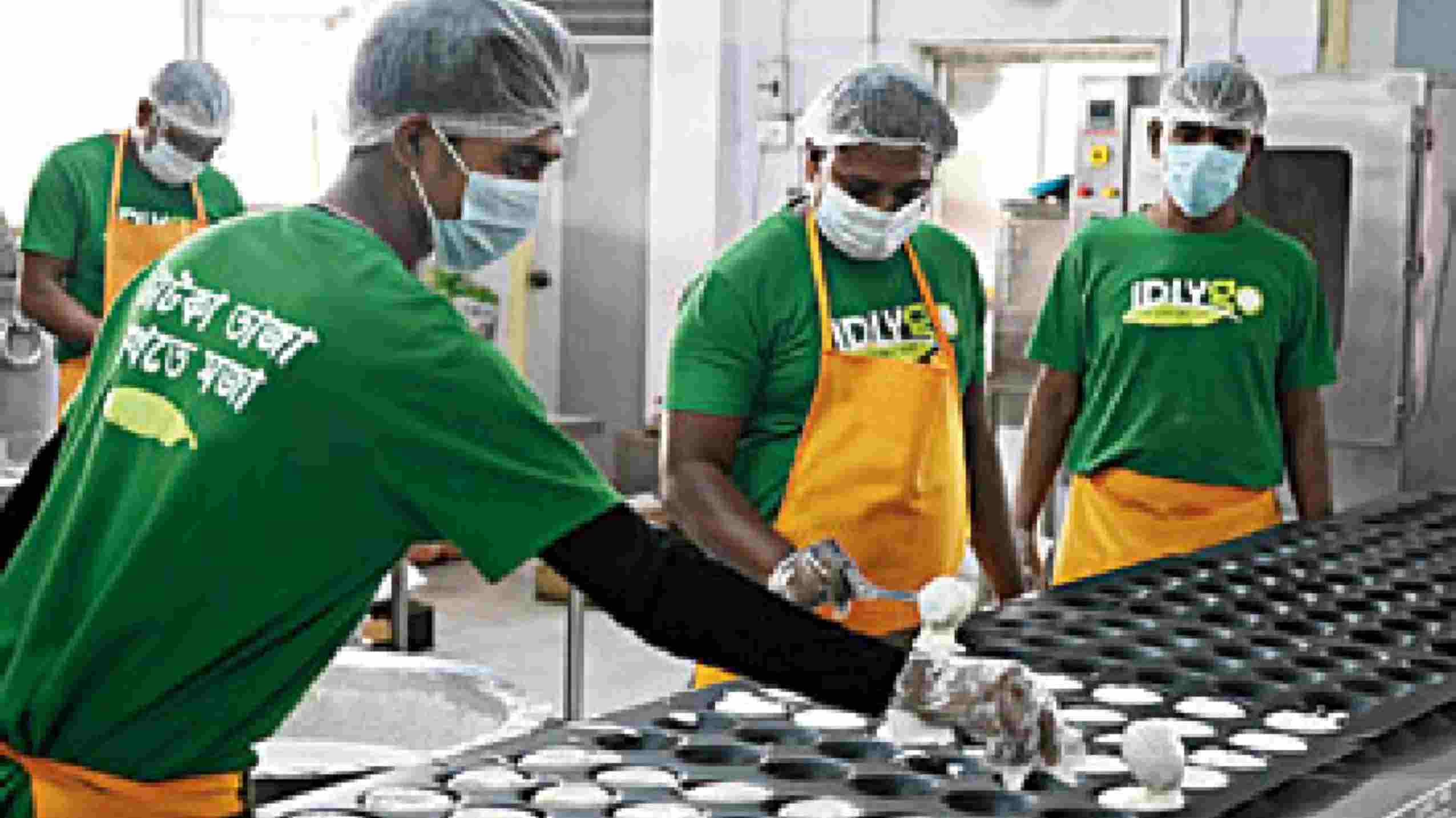 The idli batter is then poured manually in the trays