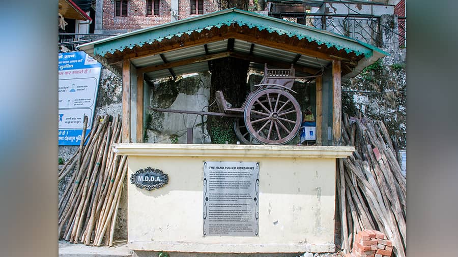 An old wooden hand-pulled rickshaw on display 
