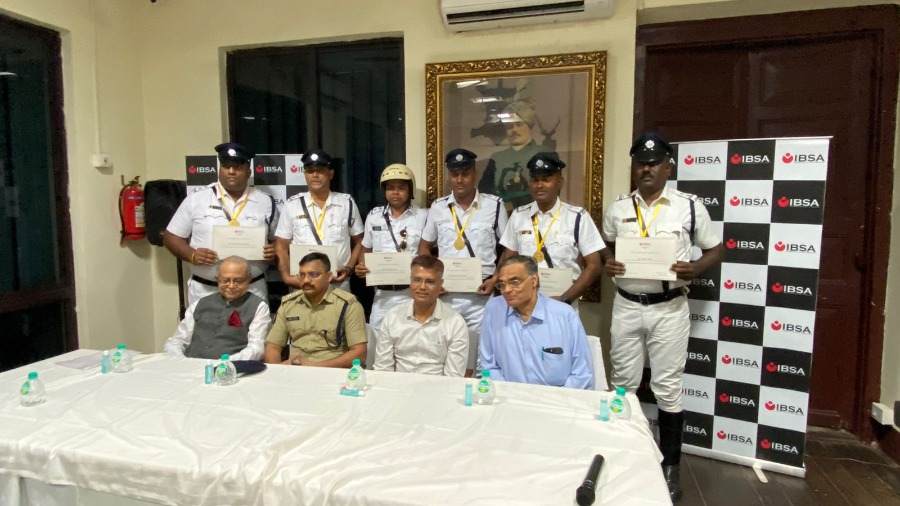 Felicitated police officers (back row) with their medals and certificates 