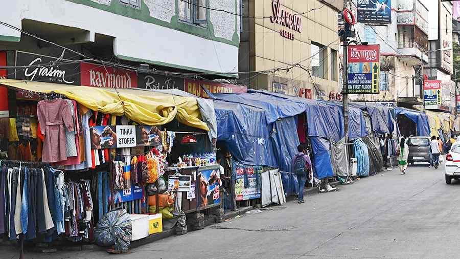 Plastic sheets cover hawkers’ stalls in Gariahat on Saturday