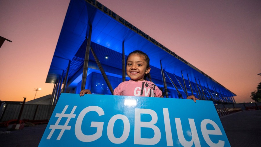 A kid holding the #goblue placard at Ahmedabad Airport in Gujarat. 